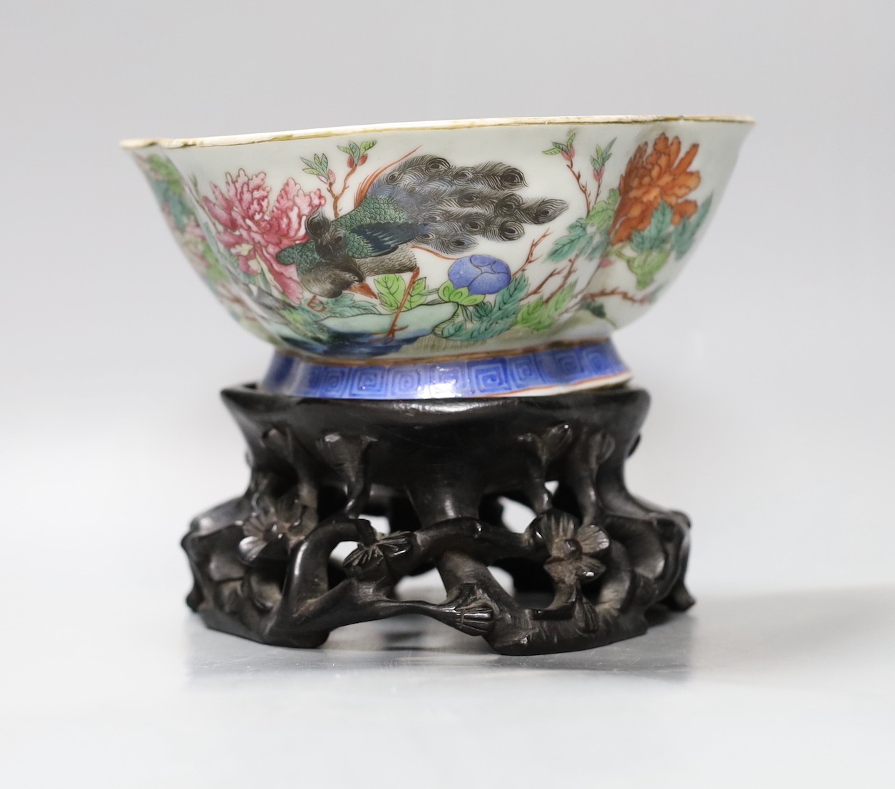 A Chinese Tongzhi famille rose dish with floral and bird decoration on carved stand, 14cm tall overall